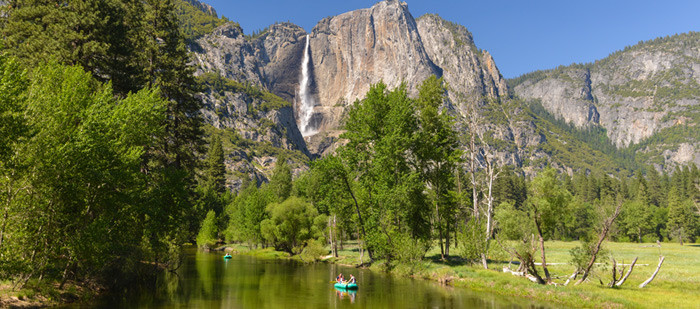 A raft floats through Yosemite Valley.