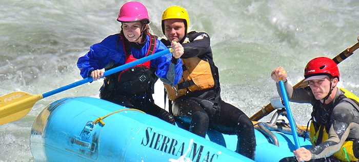 Young woman paddles raft on Cherry Creek